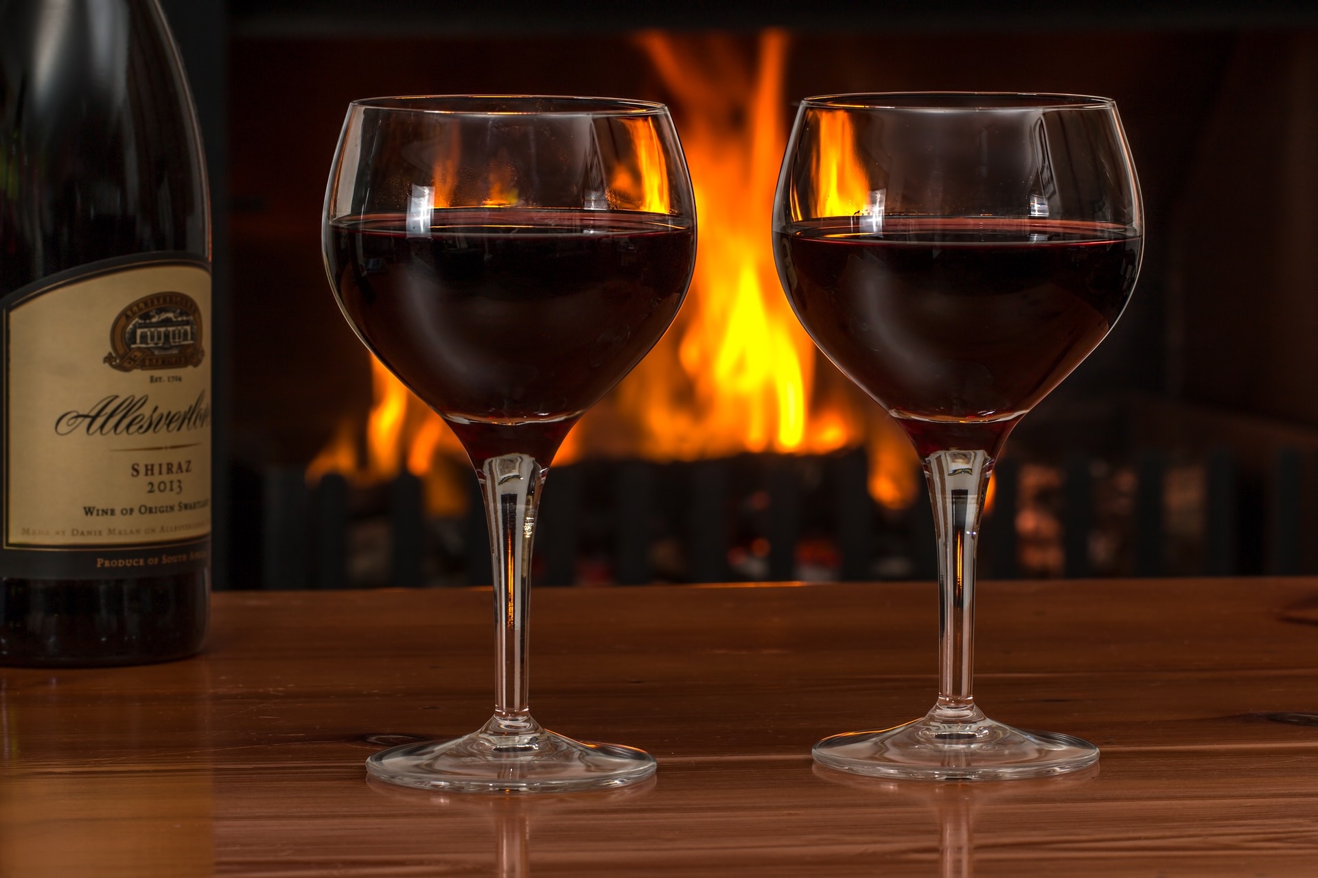 Red wine glasses in front of a fire Red wine glasses in front of a fire