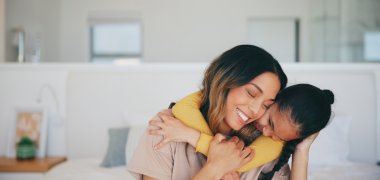 Love, hug and a mother hugging her daughter in the bedroom of their home in the morning together. Face, smile and a happy young girl embracing her single parent while on a bed in their apartment Love, hug and a mother hugging her daughter in the bedroom of their home in the morning together. Face, smile and a happy young girl embracing her single parent while on a bed in their apartment