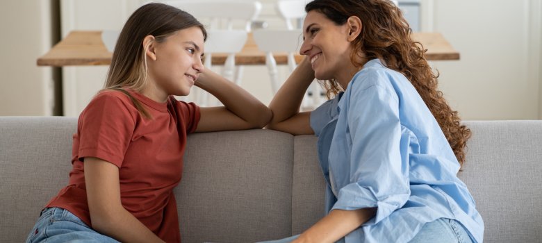 Loving mother listening to daughter with empathy and understanding, child sharing secrets with mom