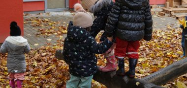 Kinder balancieren auf einem Holzstamm Kinder balancieren auf einem Holzstamm