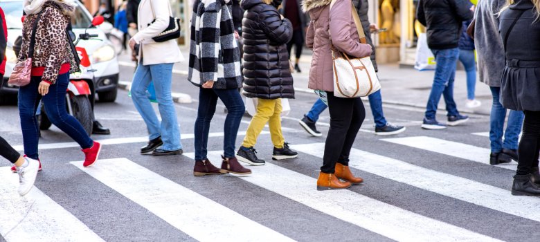 Pedestrians crossing pedestrian walkway in the city