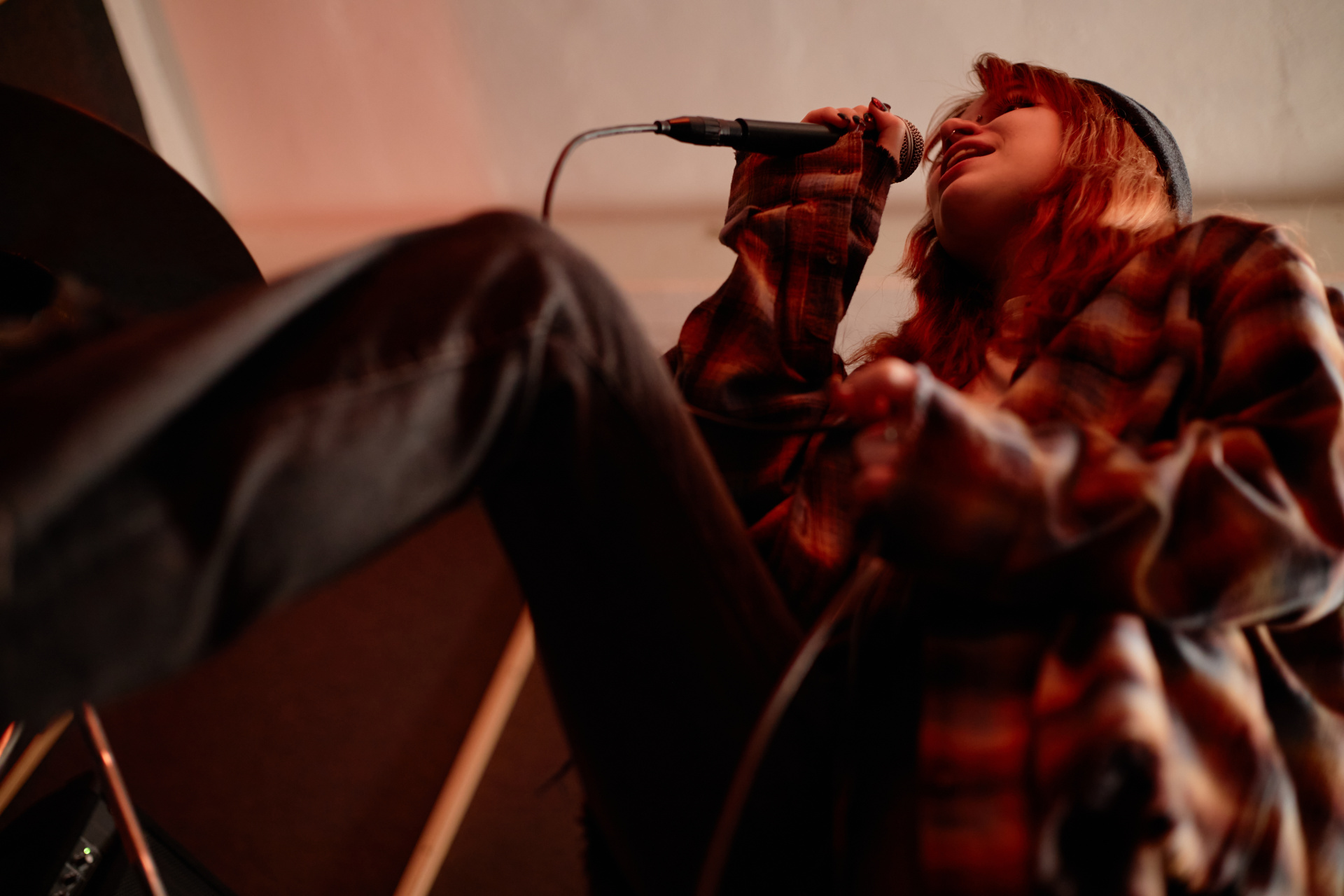 Emotional Teenage Girl Singing into Mic Performing Music with Rock Band in Studio