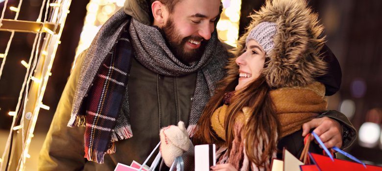 Adult couple shopping in the city during Christmas time